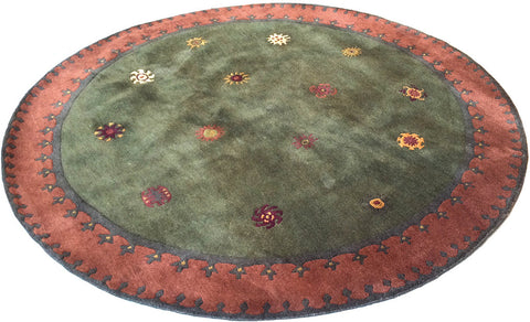 Tibetan Sun (moss) six foot round - a  subtle and playful modern area rug with rich colors